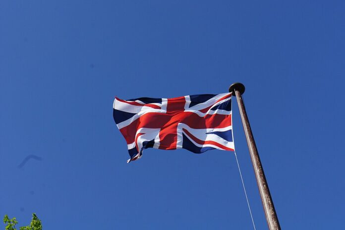 A Union Jack flag flying against the sky.